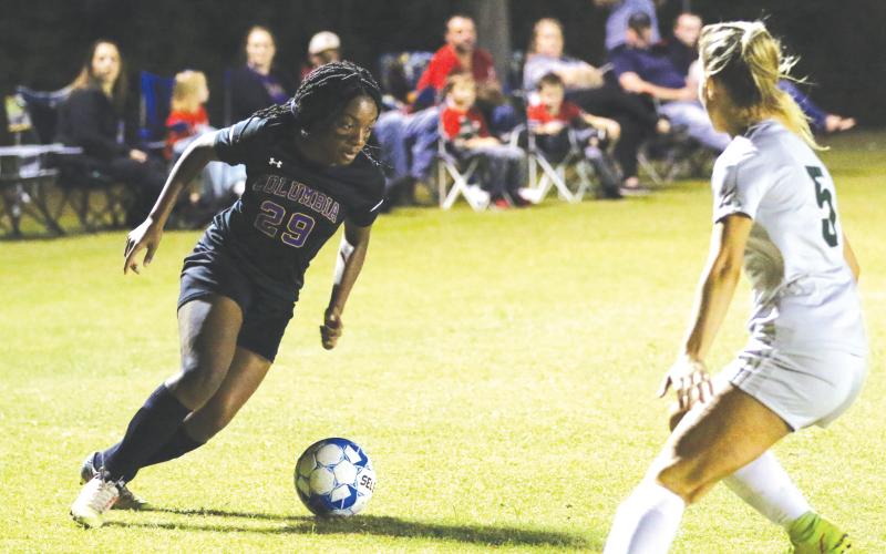 Columbia’s Olivia Kelly takes on Suwannee’s Hannah Humphries inside the penalty box during Friday night’s match. (MORGAN MCMULLEN/Lake City Reporter)