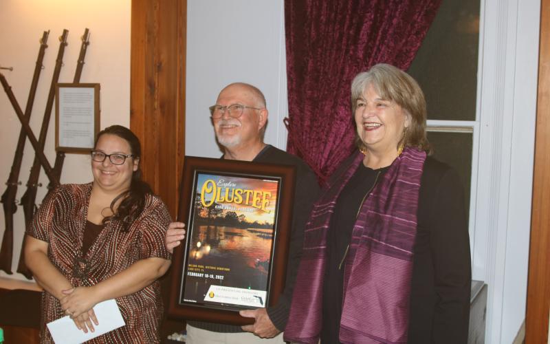 Olustee Festival photo contest winner John Clare Stokes (center) with Shannon Barker (left) and Sherri Carder during the unveiling the 2022 Olustee Festival poster. (TONY BRITT/Lake City Reporter)