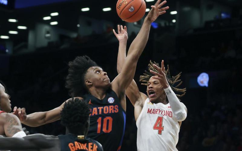 Maryland's Fatts Russell has the ball knocked away by Florida's Elijah Kennedy during Sunday's game in New York. (JASON DECROW/Associated Press)