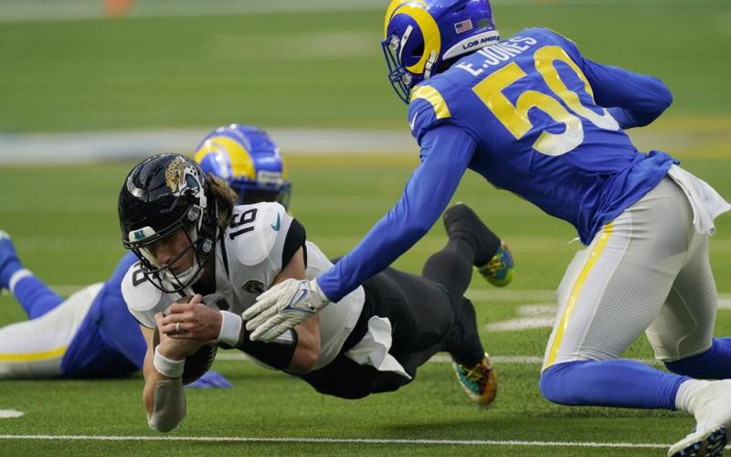 Jacksonville Jaguars quarterback Trevor Lawrence lunges for yardage against the Los Angeles Rams on Dec. 5 in Inglewood, Calif. (MARK J. TERRILL/Associated Press)