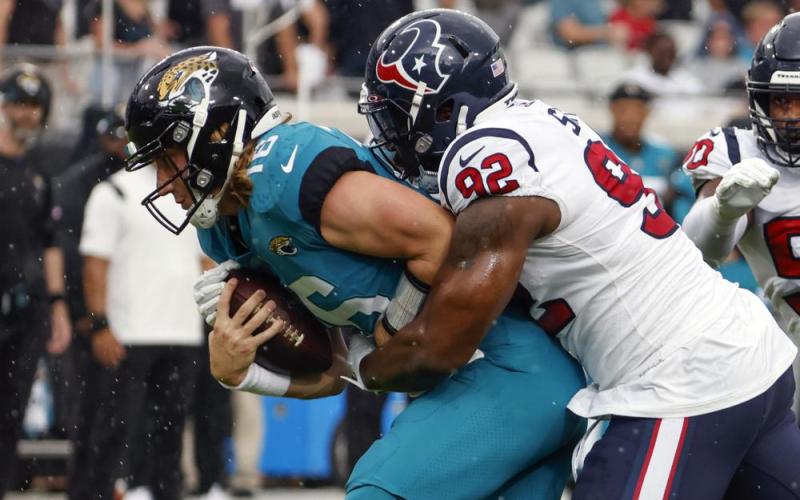 Houston Texans linebacker Chris Smith (92) sacks Jacksonville Jaguars quarterback Trevor Lawrence, left, during Sunday's game in Jacksonville. (STEPHEN B. MORTON/Associated Press)