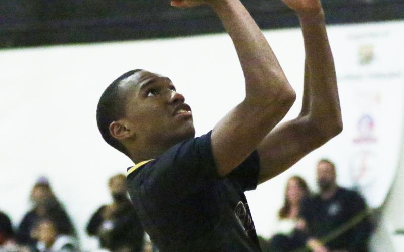 Columbia guard Caden Perry rises to shoot against Buchholz on Nov. 30. (MORGAN MCMULLEN/Lake City Reporter)