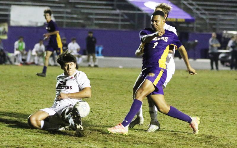 Columbia’s AJ Brinson fires a shot inside the penalty box as Bishop Kenny defenders rush in during Thursday’s match. (MORGAN MCMULLEN/Lake City Reporter)