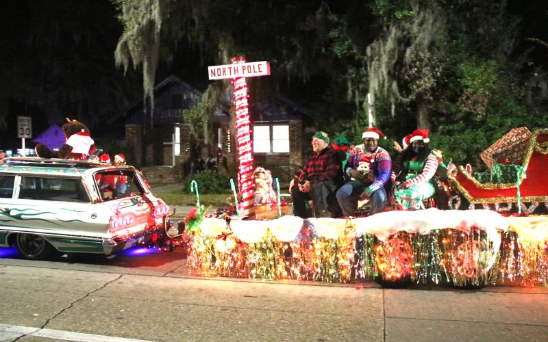 A parade float featuring Santa’s sleigh and a North Pole marker makes its way down Marion Avenue during the 2019 Christmas parade in Lake City. (FILE)