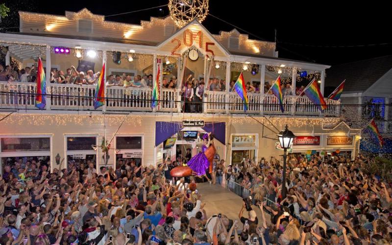 “Sushi,” portrayed by Gary Marion, is lowered to the ground in a giant facsimile of a woman’s red high heel on Duval Street on Jan. 1, 2015, at the Bourbon Street Pub in Key West. (BOB O'NEAL/Associated Press)