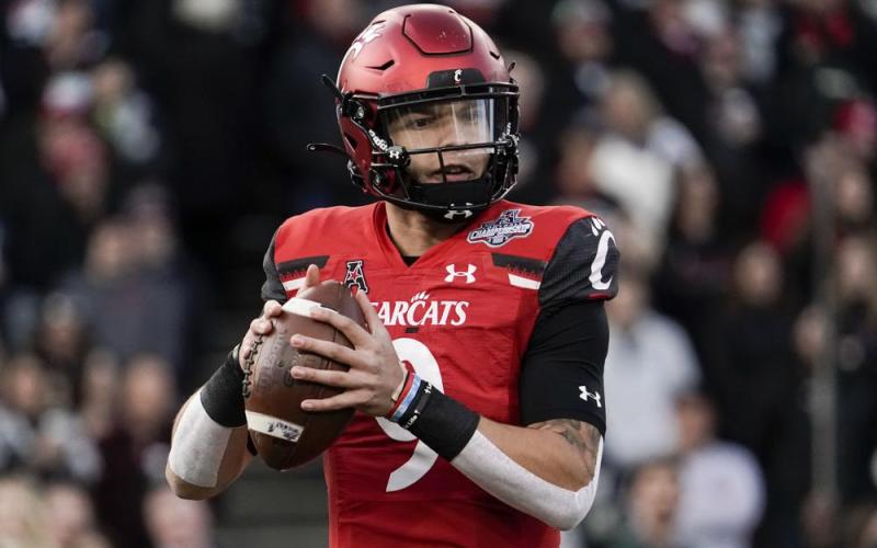 Cincinnati quarterback Desmond Ridder looks to pass from the pocket during the American Athletic Conference championship game against Houston on Dec. 4 in Cincinnati. The fourth-ranked Bearcats (13-0) get their shot in the CFP semifinal Cotton Bowl on Friday against No. 1 defending national champion Alabama. (AP File)