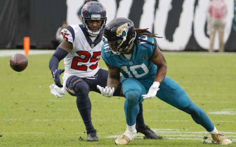A pass slips through the hands of Jacksonville Jaguars wide receiver Laviska Shenault Jr. as he is defended by Houston Texans cornerback Desmond King during Sunday's game in Jacksonville. (STEPHEN B. MORTON/Associated Press)