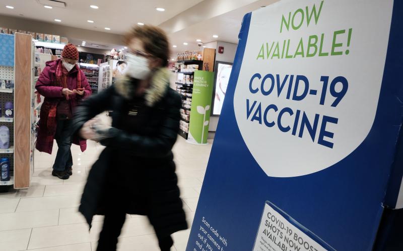 A pharmacy in Grand Central Terminal advertises the covid-19 vaccine on Dec. 9 in New York City. The CDC's new guidance about isolation could entice more Americans to seek a booster dose of the vaccine. (SPENCER PLATT/Getty Images/TNS)