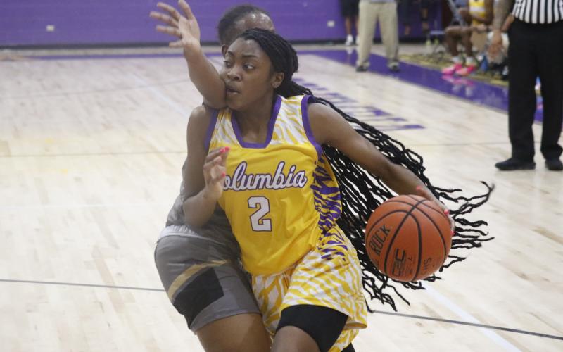 Columbia guard Na’Haviya Paxton drives by a Buchholz defender on Tuesday night. (JORDAN KROEGER/Lake City Reporter)