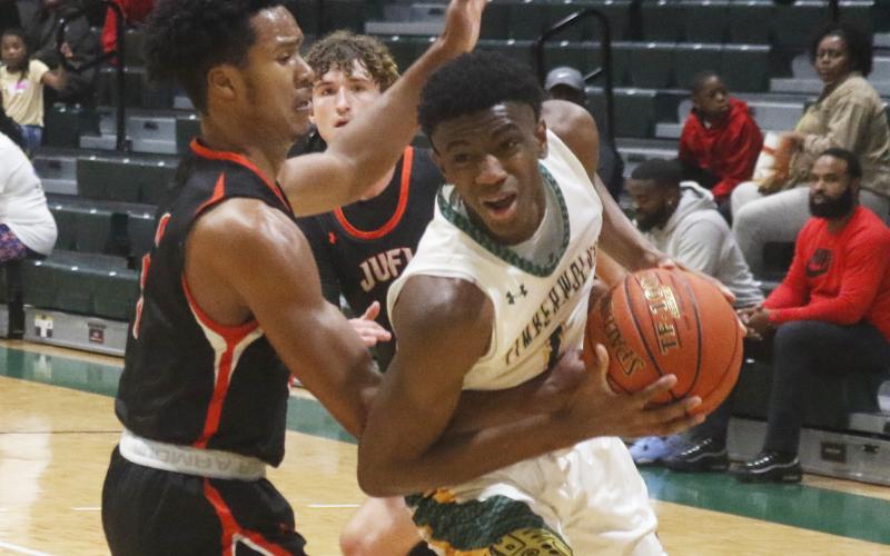 FGC's Jeremiah Barze tries to get around a Johnson U. defender to shoot on Thursday night.  (JORDAN KROEGER/Lake City Reporter)