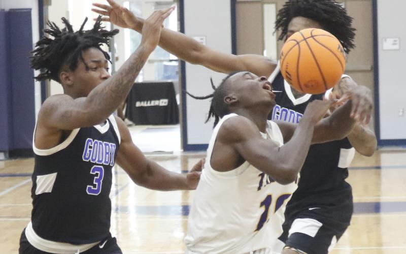 Columbia guard Isaac Broxey has the ball knocked away from him by a Godby defender during the final day of the Hitchcock’s Challenge at Legacy Park on Thursday in Alachua. (JORDAN KROEGER/Lake City Reporter)