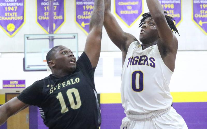 Columbia forward Marcus Peterson shoots over The Villages forward Ja-Quez Oliver on Friday night. (JORDAN KROEGER/Lake City Reporter)