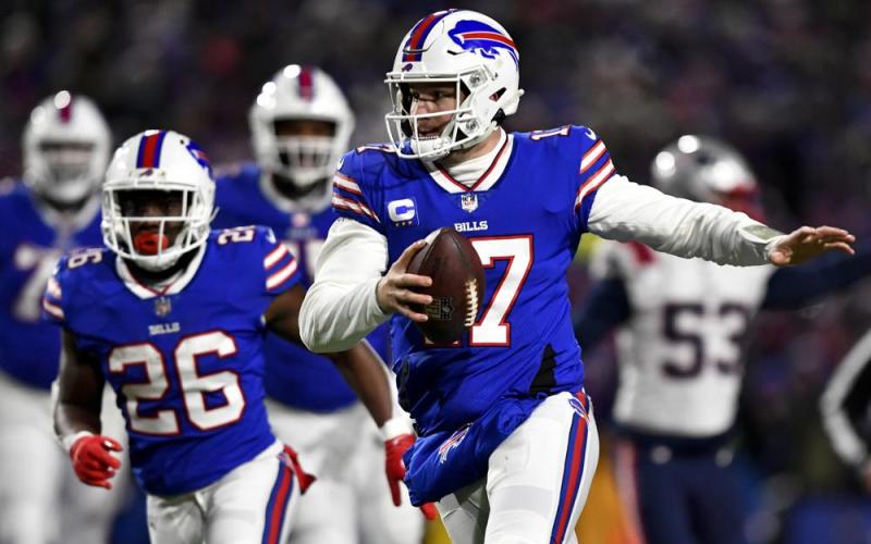 Buffalo Bills quarterback Josh Allen runs the ball during Saturday's wild-card playoff game against the New England Patriots in Orchard Park, N.Y. (ADRIAN KRAUS/Associated Press)
