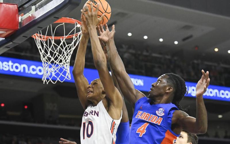 Auburn forward Jabari Smith (10) and Florida forward Anthony Duruji (4) battle for a rebound during Saturday's game in Auburn, Ala. (JULIE BENNETT/Associated Press)