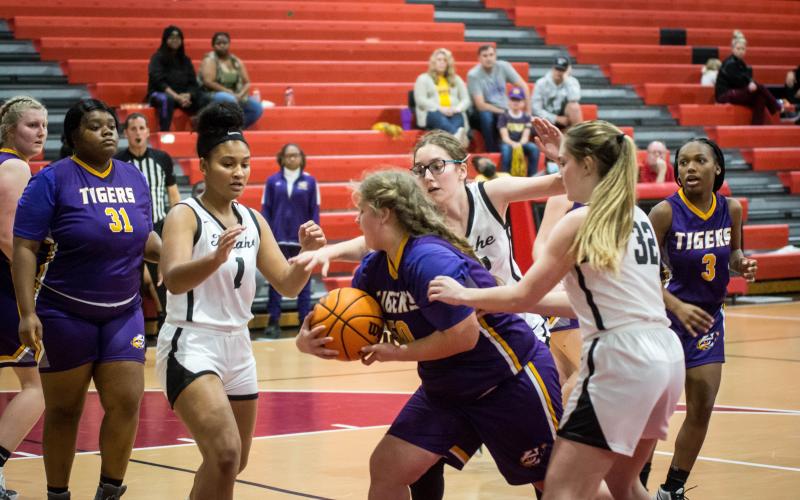 Fort White’s Ciara Byrd (1), Lisa Gall (middle) and Kaysen Wilcox (32) surround a Union County player on defense on Tuesday night. (CHRISTINA FEAGIN/Special to the Reporter)