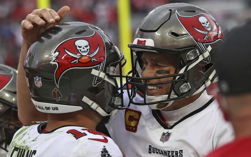 Tampa Bay Buccaneers quarterback Tom Brady, right, celebrates with wide receiver Mike Evans after Evans caught a touchdown pass against the Philadelphia Eagles during Sunday's wild-card playoff game in Tampa. (MARK LOMOGLIO/Associated Press)