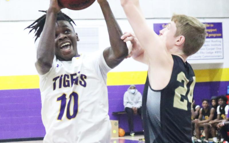 Columbia guard Isaac Broxey rises to shoot as The Villages Charter forward Sam Walters contests on Friday night. (JORDAN KROEGER/Lake City Reporter)