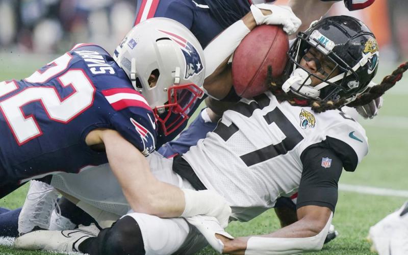 Jacksonville Jaguars cornerback Chris Claybrooks is taken down by New England Patriots defensive back Cody Davis during Sunday's game in Foxborough, Mass. (STEVEN SENNE/Associated Press)