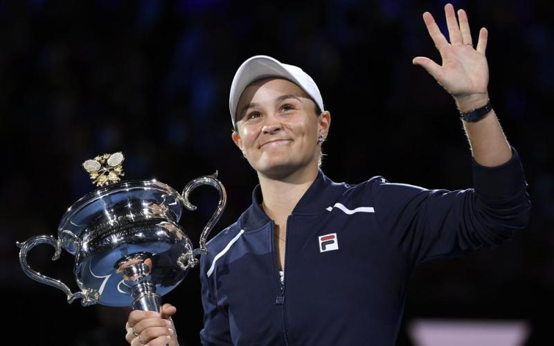 Ash Barty waves as she holds the Daphne Akhurst Memorial Cup after defeating Danielle Collins in the women's singles final at the Australian Open on Saturday in Melbourne, Australia. (ANDY BROWNBILL/Associated Press)