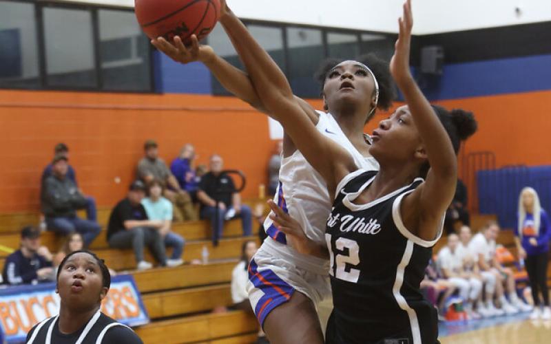 Fort White forward Isreal Hart (12) blocks a layup attempt from Branford’s Zjamyah Wilson during Thursday night’s 56-26 Indians win at LeNelle Phillips Morgan Gym. (PAUL BUCHANON/Special to the Reporter)