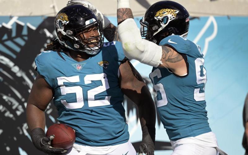 Jacksonville Jaguars defensive tackle DaVon Hamilton (52) celebrates after recovering an Indianapolis Colts fumble with teammate defensive end Adam Gotsis during Sunday's game in Jacksonville. (PHELAN M. EBENHACK/Associated Press)