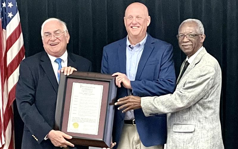Florida Forestry Association President Carlton Jones, center, is presented a proclamation recognizing him as Lake City’s Arbor Day honoree by Mayor Stephen Witt and Councilman Eugene Jefferson. (COURTESY)