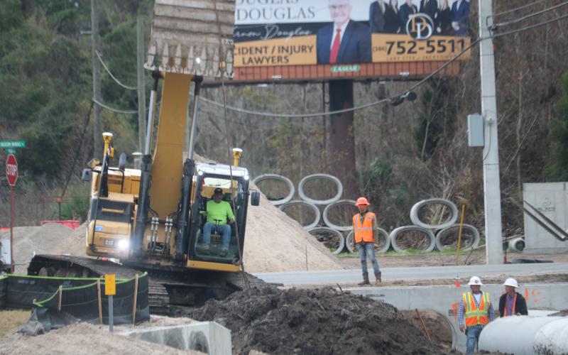 A construction crew works on the drainage system near the future roundabout at Northwest Bascom Norris Drive and U.S. Highway 41. (TONY BRITT/Lake City Reporter)