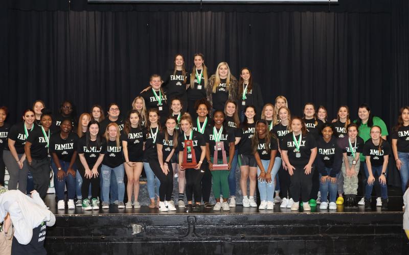 Suwannee’s girls weightlifting team poses with the Region 1-1A trophy on Friday night. (PAUL BUCHANAN/Special to the Reporter)