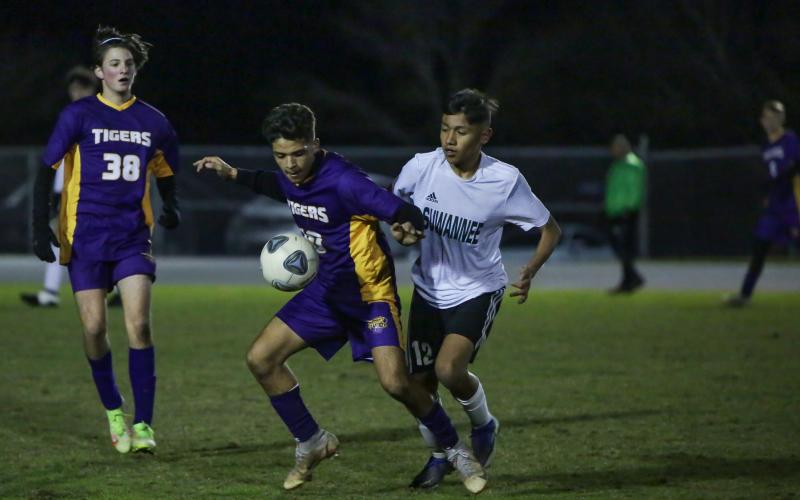 Columbia junior Jason Caballero (left) shields the ball away from Suwannee midfielder Joel De La Cruz during Friday night’s game at Columbia High School. (BRENT KUYKENDALL/Lake City Reporter)