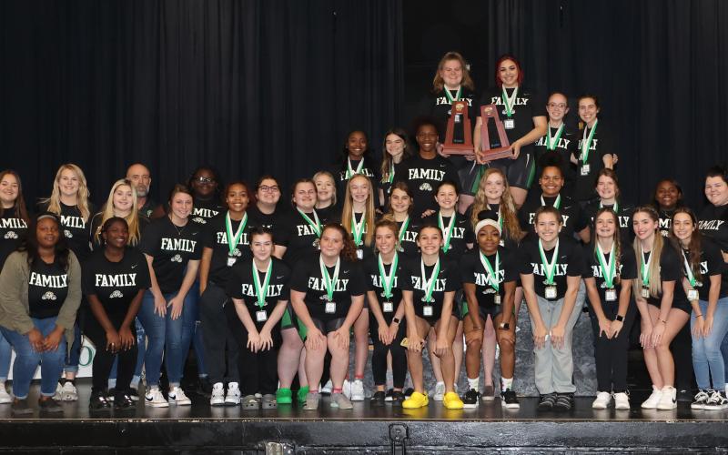 Suwannee’s girls weightlifting team poses with the District 4-1A trophy on Friday. (PAUL BUCHANAN/Special to the Reporter)