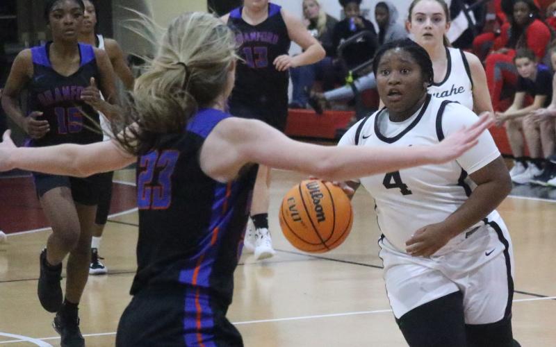 Fort White guard N’Coreyia Atkins pushes the ball up the floor after a steal against Branford during Thursday’s District 6-1A semifinal. (JORDAN KROEGER/Lake City Reporter)