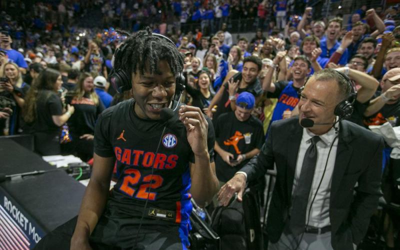 Florida guard Tyree Appleby (left) talks with broadcasters as he celebrates Florida's 63-62 win over Auburn on Saturday  in Gainesville. (ALAN YOUNGBLOOD/Associated Press)