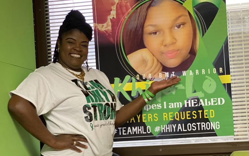 LaKesia Hendon shows off a poster of MiKhiya Hendon in her hospital room at Shands. (COURTESY)