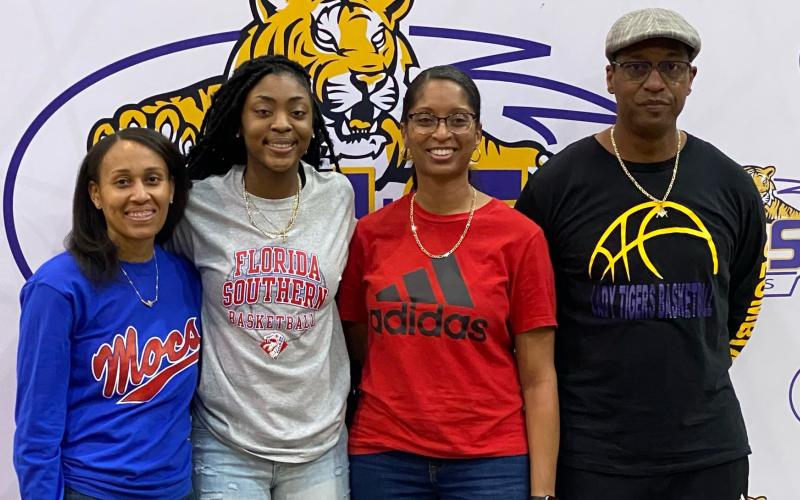 Columbia guard Na’Haviya Paxton (center left) signed her letter of intent to play at Florida Southern on Saturday. She is pictured with Columbia assistant coach Erica Mayo (left), Columbia assistant coach Keisha Kimble (center right) and Columbia head coach Anthony Perry. (COURTESY)