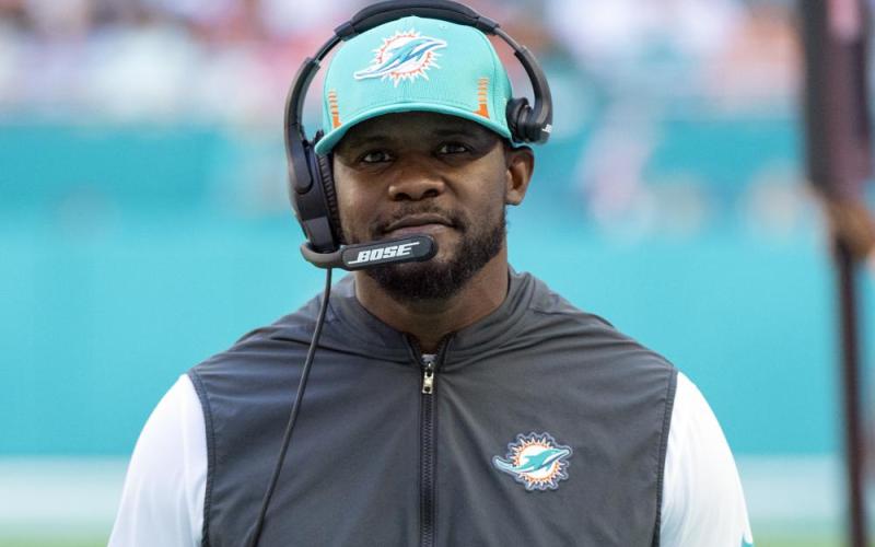 Former Miami Dolphins head coach Brian Flores smiles on the sidelines during a game against the Carolina Panthers on Nov. 28, 2021, in Miami Gardens. (AP FILE)