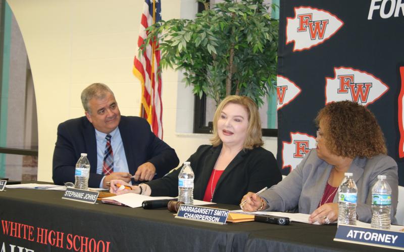 Stephanie Johns (middle) speaks as Superintendent Lex Carswell and Chairperson Narragansett Smith watch during Tuesday’s school board meeting. (TONY BRITT/Lake City Reporter)