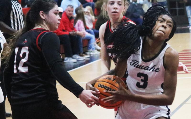 Fort White guard Jacovya Major tries to hold onto possession of the ball as she drives past Lafayette’s Kayla Castillo (23) and Emily Lyons (12) during Thursday night’s Region 3-1A semifinal. (JORDAN KROEGER/Lake City Reporter)