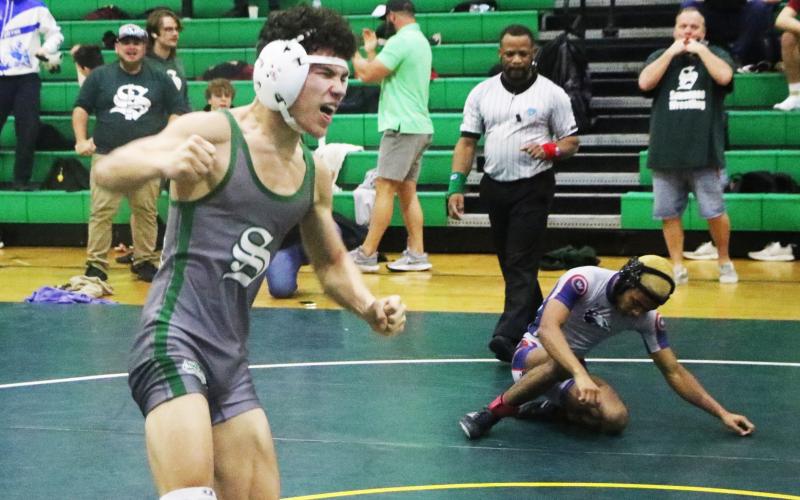 Suwannee wrestler Topher Pearson celebrates after winning the District 2-1A title in he 106 class on Friday. (MORGAN MCMULLEN/Lake City Reporter)