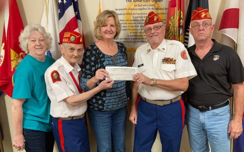 Spirit of the Suwannee Music Park General Manager Teena Peavey recently presented the Tri-County Veterans Fund with a $40,000 check from donations made during the Suwannee Lights event at the park. Pictured with Peavey (center) are Tri-County Veterans Fund volunteers Pat Walsh (from left), Mike Russell, Jim Kennedy and Russ Carson. (COURTESY)