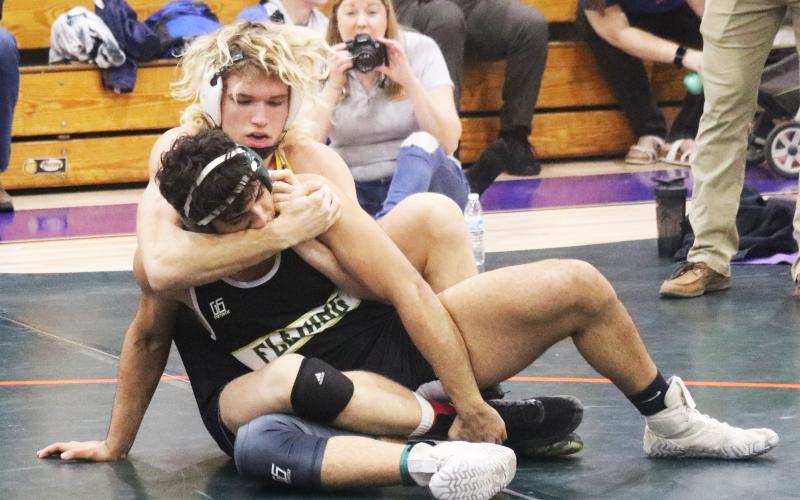 Columbia’s Joseph Rice wrestles with Fleming Island’s Joshua Sandoval during Wednesday’s District 2-2A title match in the 170 class. (JORDAN KROEGER/Lake City Reporter)