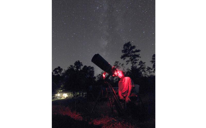 Late astrophotographer Steve Speck sets up his camera and telescope in the night hours. (COURTESY)