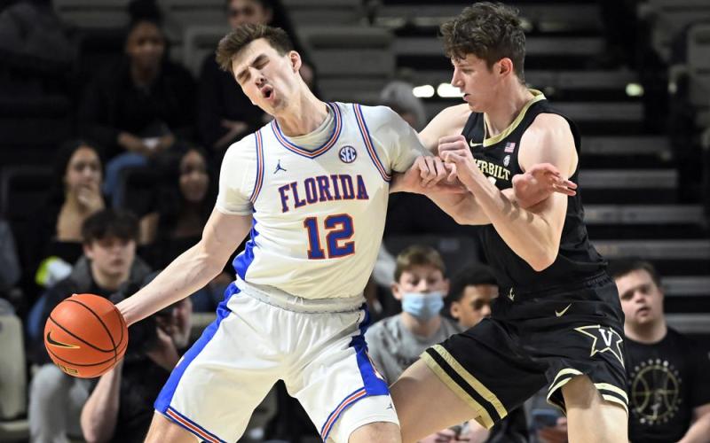 Florida forward Colin Castleton (12) drives against Vanderbilt center Liam Robbins during Tuesday’s game in Nashville, Tenn. (MARK ZALESKI/Associated Press)