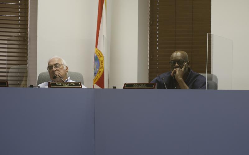 Mayor Stephen Witt (left) and Lake City Councilman Jake Hill listen during Wednesday’s interviews. (JAMIE WACHTER/Lake City Reporter)