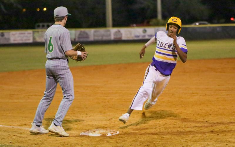 Columbia first baseman Brayden Thomas turns off third base and heads home to score a run against Suwannee on Tuesday night. (BRENT KUYKENDALL/Lake City Reporter)