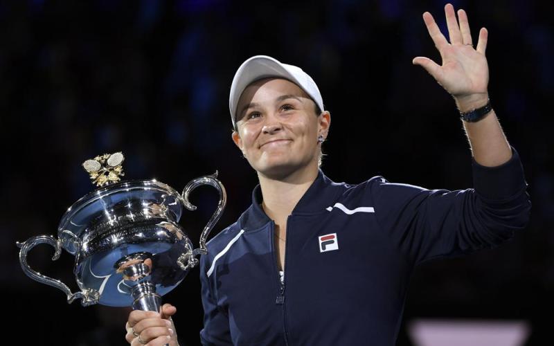 Ash Barty waves as she holds the Daphne Akhurst Memorial Cup after defeating Danielle Collins in the final at the Australian Open on Jan. 29 in Melbourne, Australia. (AP File)