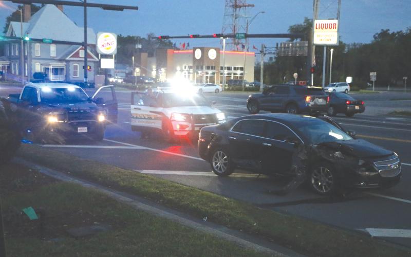 Columbia County Sheriff’s deputies block traffic in one lane heading westbound on U.S. Highway 90 near NW Main Blvd. in front of a wrecked Chevy Malibu on Wednesday night. (MORGAN MCMULLEN/Lake City Reporter)