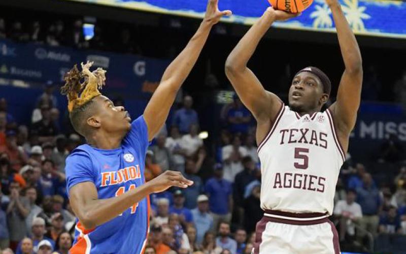 Texas A&amp;M guard Hassan Diarra makes the game-winning shot over Florida guard Kowacie Reeves during overtime of Thursday's game at the Southeastern Conference tournament in Tampa. (CHRIS O'MEARA/Associated Press)