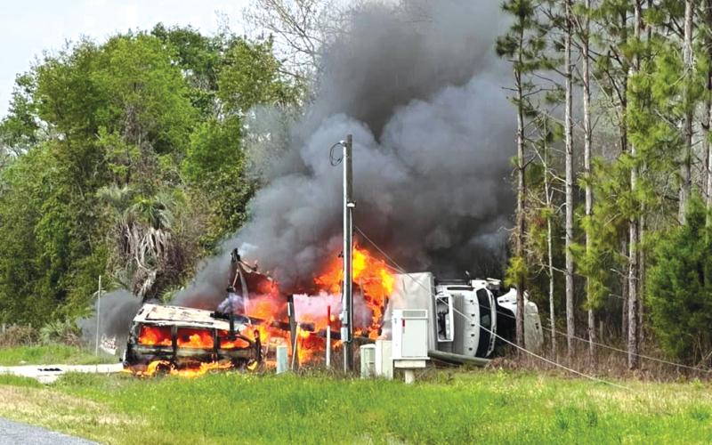 A semi-truck carrying a delivery of liquor burns off the side of County Road 250 near the intersection of 201st Road. (COURTESY)