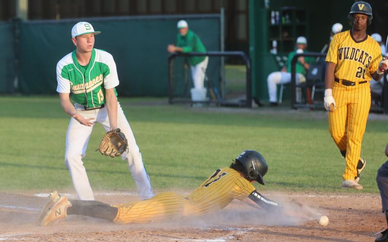 The ball gets away from Suwannee’s Ethan Layton as Valdosta’s Sam Houston slides safely into home plate during Tuesday’s game. (PAUL BUCHANAN/Special to the Reporter)