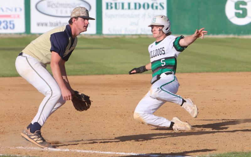Suwannee’s Josh Fernald slides into third base ahead of a throw against Holmes County on Monday. (PAUL BUCHANAN/Special to the Reporter)